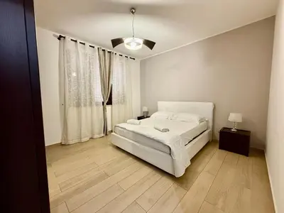 a bedroom with a white bed and a window at Infinity Home in Palermo