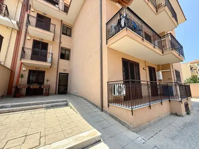 an apartment building with balconies and a courtyard at Infinity Home in Palermo