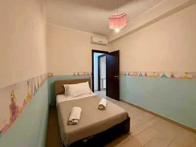 a bedroom with a bed in a room at Infinity Home in Palermo