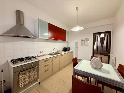 a kitchen with a stove top oven next to a table at Infinity Home in Palermo