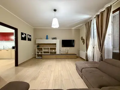 a living room with a couch and a television at Infinity Home in Palermo