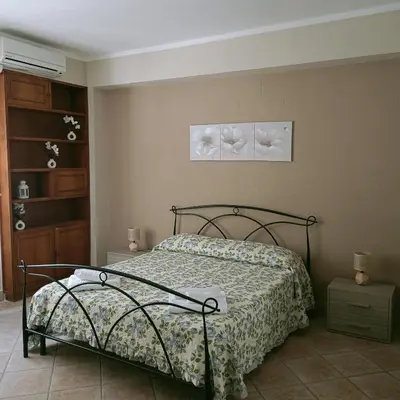 a bedroom with a bed with a floral bedspread at Stella del mare in Palermo