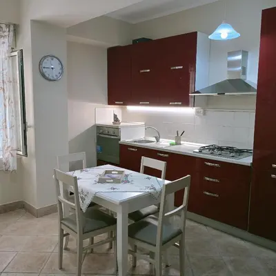 a kitchen with a table and chairs and a sink at Stella del mare in Palermo