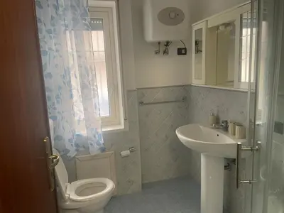 a bathroom with a toilet and a sink at Stella del mare in Palermo