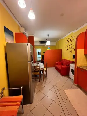 a kitchen and a living room with a refrigerator at Monolocale Signorile in Castellammare del Golfo