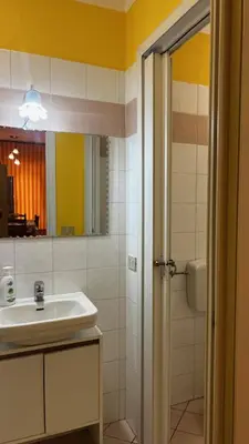 a bathroom with a sink and a mirror and a shower at Monolocale Signorile in Castellammare del Golfo