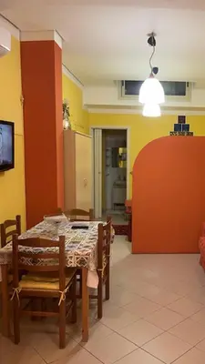 a dining room with a table and chairs in a room at Monolocale Signorile in Castellammare del Golfo
