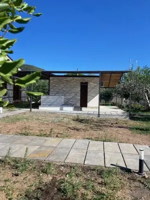 a building with a walkway in front of a house at I Carrubi in Lascari