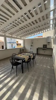a room with tables and chairs in a building at Casarkeb in Terrasini
