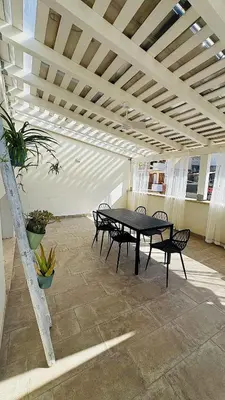 a patio with a table and chairs in a building at Casarkeb in Terrasini