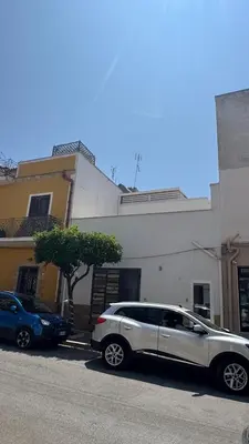 a white car parked in front of a building at Casarkeb in Terrasini