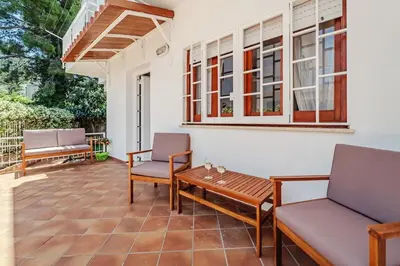 a patio with two chairs and a wooden table at Domus Rosae in Palermo