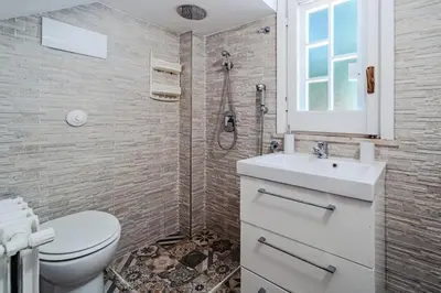 a bathroom with a toilet and a sink and a shower at Domus Rosae in Palermo