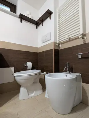a bathroom with a white toilet and a bidet at A casa della Vero in Palermo
