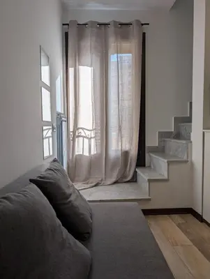 a living room with a couch and a window at A casa della Vero in Palermo