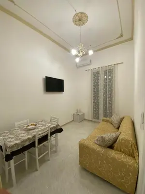 a living room with a couch and a dining room table at Corso Butera 489 in Bagheria