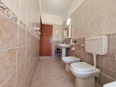a bathroom with a toilet and a sink at House Calamigna in Ventimiglia di Sicilia