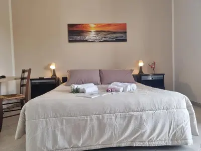 a bedroom with a bed with two towels on it at House Calamigna in Ventimiglia di Sicilia
