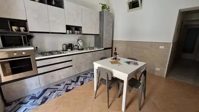 a kitchen with a white table and a stove at The brothers house appartamento alla Zisa in Palermo
