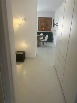 a hallway leading to a kitchen and a dining room at cielo blu in San Vito lo Capo