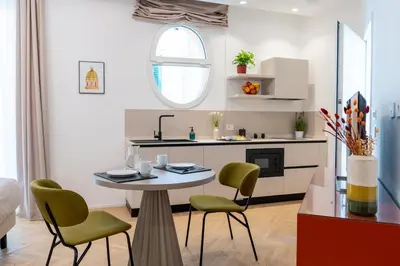 a kitchen with a table and chairs in a room at Pupa Ru Capu in Palermo