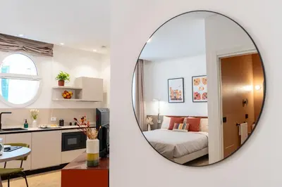 a room with a bed and a mirror at Pupa Ru Capu in Palermo
