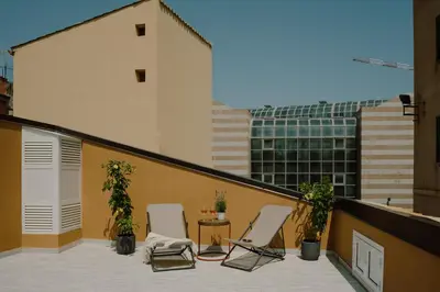 a balcony with two chairs and a table on a building at Pupa Ru Capu in Palermo