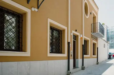 a facade of a building with windows on a street at Pupa Ru Capu in Palermo