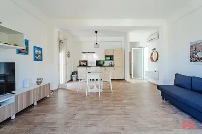 a living room with a blue couch and a table at Charming Holiday Home in Palermo in Palermo