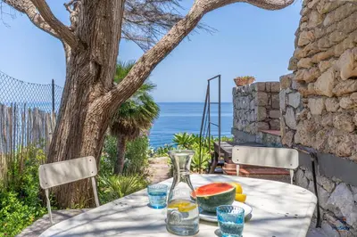 a table with a vase and watermelon on it at Verosicily Villa Aspra in Bagheria