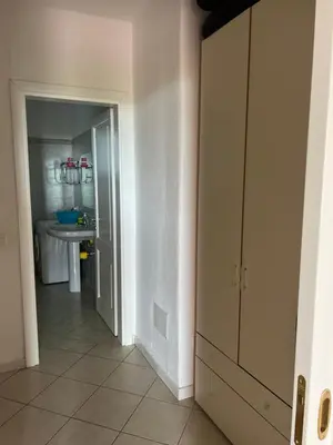 a hallway with a door to a bathroom with a sink at Residenza Uliveto in Monreale