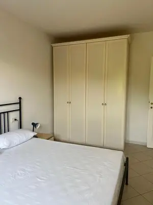 a bedroom with a large white bed and cabinets at Residenza Uliveto in Monreale
