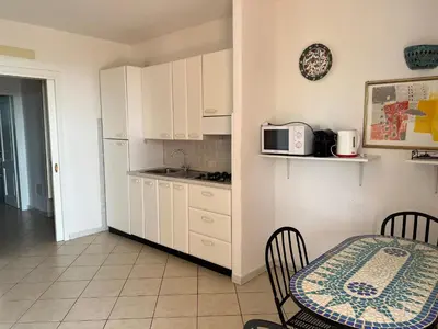 a small kitchen with a table and a microwave at Residenza Uliveto in Monreale