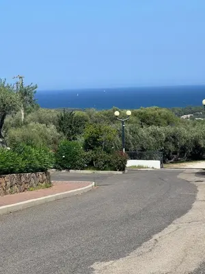 an empty street with the ocean in the background at Residenza Uliveto in Monreale