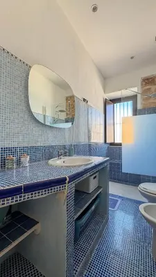 a bathroom with a sink and a mirror at Appartamento Cinisi in Cinisi
