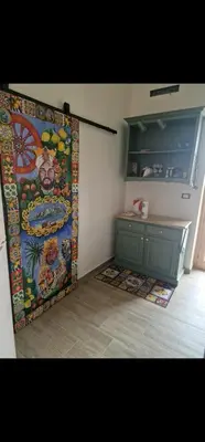 a kitchen with a large painting on the wall at Marea in Palermo