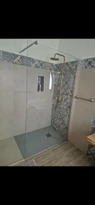 a bathroom with a shower with a glass door at Marea in Palermo