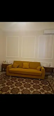 a living room with a yellow couch in a room at Marea in Palermo