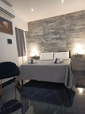 a bedroom with a bed and a stone wall at La Stanza del Viaggiatore in Palermo