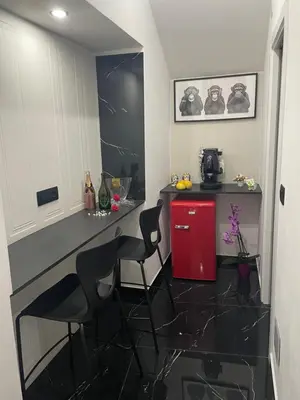 a kitchen with a red refrigerator and two chairs at La Stanza del Viaggiatore in Palermo
