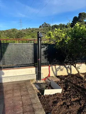 a pole with a red hose in a garden at Valley Casale in Belmonte Mezzagno