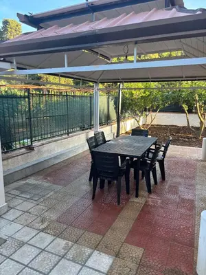 a black table and chairs under an umbrella at Valley Casale in Belmonte Mezzagno