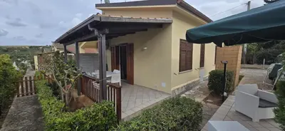 a small house with a fence and a patio at Lulu' Home - Guidaloca - Scopello in Scopello