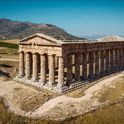 an ancient building with columns on a hill at Lulu' Home - Guidaloca - Scopello in Scopello