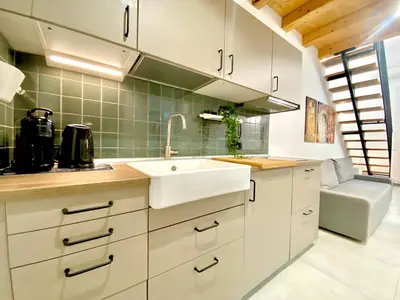 a kitchen with white cabinets and a sink at Loft Pergola, posizione strategica in Castellammare del Golfo