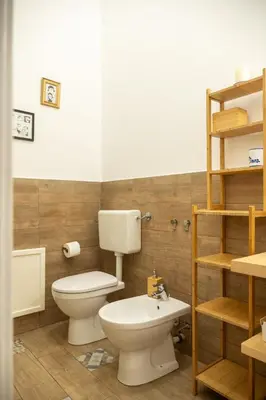 a bathroom with a toilet and a sink at La suite al Teatro Massimo in Palermo