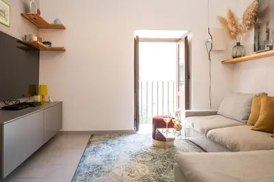 a living room with a couch and a table at La suite al Teatro Massimo in Palermo