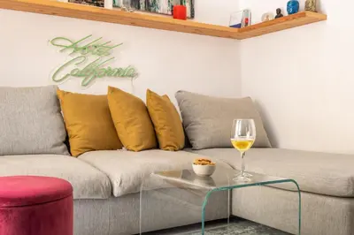 a living room with a couch and a glass table at La suite al Teatro Massimo in Palermo