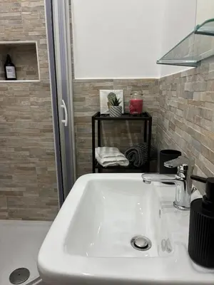 a white sink in a bathroom next to a counter at Mamma Chica Alloggio Turistico a Palermo in Palermo