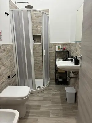 a bathroom with a shower and a toilet and a sink at Mamma Chica Alloggio Turistico a Palermo in Palermo